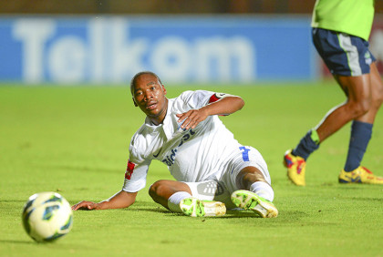 Tshepo Gumede of Platinum Stars fouls Sibusiso Vilakazi of Bidvest Wits in the box to award Wits a penalty during the Absa Premiership football match between Bidvest Wits and Platinum Stars at the Bidvest Stadium in Johannesburg on April 17, 2013©Barry Aldworth/BackpagePix